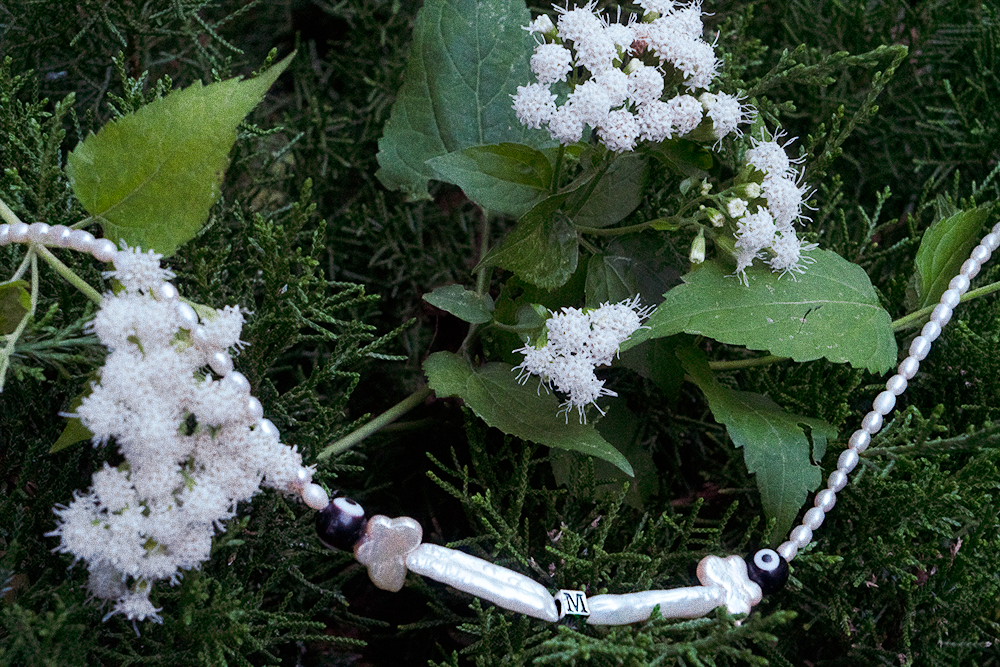 necklace in white flowers and bushes